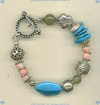 Bracelet with Arizona turquoise chips and nugget, pink coral, grossiler garnet, and hand made sterling silver beads and toggle. - Click for a larger picture