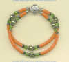 Natural coral heishi, green freshwater pearl, and peridot gemstone double strand bracelet with handmade silver beads. - Click for a larger picture