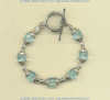Bracelet with faceted blue quartz gemstones and hand made sterling silver bead and toggle.				
 - Click for a larger picture