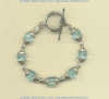 Bracelet with faceted blue quartz gemstones and hand made sterling silver bead and toggle.
- Click for a larger picture