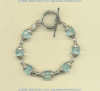 Bracelet with faceted blue quartz gemstones and hand made sterling silver bead and toggle.				
 - Click for a larger picture