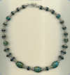 Necklace with Peruvian turquoise and frosted black onyx semi precious gemstones, and hand made sterling silver beads. - Click for a larger picture