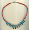 Necklace with turquoise gemstones, red coral, and hand made sterling silver beads. - Click for a larger picture