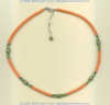 Natural coral heishi, green freshwater pearl, and peridot gemstone necklace with handmade silver beads. - Click for a larger picture