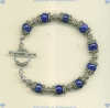 Bracelet with 8 mm lapis lazuli semi-precious gemstones and hand made sterling silver beads and toggle. - Click for a larger picture