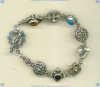 Sterling silver bracelet with mixed bezel set cabochon gemstones and ornate sterling silver beads and toggle. - Click for a larger picture