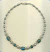Spiderweb blue turquoise and handmade sterling silver bead necklace. - Click for a larger picture
