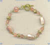 Gold fill, strawberry quartz, and mother of pearl bracelet.  The bracelet is made of 14K/Gold Fill beads and strawberry quartz faceted gemstones and pink mother of pearl nuggets hand wired together with 14K/Gold Fill wire to form a gemstone chain.  The toggle is also 14K/Gold Fill.  The length is 7 3/4 inches. - Click for a larger picture
